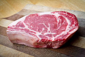 Thick Bone-In Rib Eye Steak on a cutting board